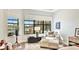 Sitting room with large windows, comfortable chair, and lake view at 7211 Prestbury Cir, Lakewood Ranch, FL 34202