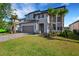 Attractive two-story home featuring a manicured lawn, palm trees, and a gray two-car garage at 7533 Nighthawk Drive, Sarasota, FL 34241