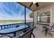 Relaxing outdoor balcony with comfortable seating overlooking a body of water and lush landscaping at 7803 Grand Estuary Trl # 303, Bradenton, FL 34212