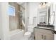 Well-lit bathroom featuring a combined shower and tub with contemporary fixtures and design at 8281 Redonda Loop, Lakewood Ranch, FL 34202