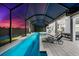 Stunning pool with attached spa and outdoor kitchen, all set in a screened enclosure with lake views at 8281 Redonda Loop, Lakewood Ranch, FL 34202