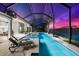 Luxurious screened-in pool with integrated spa and sun loungers, perfect for relaxing evenings and sunset views at 8281 Redonda Loop, Lakewood Ranch, FL 34202