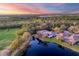 Aerial view of the property showcasing a lake and golf course, surrounded by lush greenery at 8610 51St E Ter, Bradenton, FL 34211