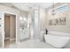 Modern bathroom with a freestanding tub, marble accents, and elegant chandelier lighting at 8610 51St E Ter, Bradenton, FL 34211