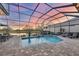 Screened-in pool overlooking a tranquil lake, perfect for relaxation and enjoying serene sunsets at 8610 51St E Ter, Bradenton, FL 34211