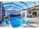 Screened-in pool area with a sparkling pool, patio furniture, and well-maintained patio at 8610 51St E Ter, Bradenton, FL 34211