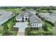 Stunning aerial view of grand home with mature landscaping, brick drive, and lush surroundings at 8847 Colonels Ct, Sarasota, FL 34240