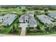 Stunning aerial view of luxury home, lush landscaping, and golf course at 8847 Colonels Ct, Sarasota, FL 34240