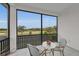 Inviting balcony with seating and a view of the lush, green golf course at 8847 Colonels Ct, Sarasota, FL 34240