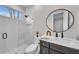 Modern bathroom featuring glass enclosed shower and dark wood vanity at 8847 Colonels Ct, Sarasota, FL 34240
