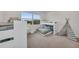 Bright bedroom featuring a bunk bed, a teepee, and a large window offering a view of the golf course at 8847 Colonels Ct, Sarasota, FL 34240