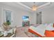 Light-filled bedroom with pool and golf course views features stylish decor and comfortable seating area at 8847 Colonels Ct, Sarasota, FL 34240