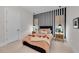 Stylish bedroom with a bold black and white striped accent wall and modern decor at 8847 Colonels Ct, Sarasota, FL 34240