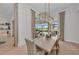 Bright dining room with modern light fixture and views of the pool and golf course at 8847 Colonels Ct, Sarasota, FL 34240
