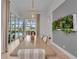 Bright dining room with long table, accent lighting, and views of the pool at 8847 Colonels Ct, Sarasota, FL 34240
