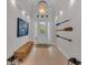Bright entryway with white walls, hardwood floors, and stylish decor at 8847 Colonels Ct, Sarasota, FL 34240