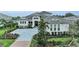 Elegant home with paved driveway and lush landscaping at 8847 Colonels Ct, Sarasota, FL 34240