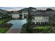 Elegant home showcasing manicured landscaping, inviting entrance, and brick paver driveway at 8847 Colonels Ct, Sarasota, FL 34240