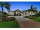 Beautiful home with manicured landscaping, brick-lined driveway and three-car garage at 8847 Colonels Ct, Sarasota, FL 34240