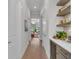 Hallway featuring a stylish wine bar with floating shelves, marble backsplash, and views to outdoor area at 8847 Colonels Ct, Sarasota, FL 34240