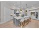 Open kitchen featuring a large gray island with bar seating, stainless steel appliances, and white cabinetry at 8847 Colonels Ct, Sarasota, FL 34240