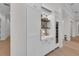 Custom dry bar with floating shelves, a wine refrigerator, and ample storage at 8847 Colonels Ct, Sarasota, FL 34240