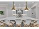 Bright kitchen featuring a large island, bar seating, and modern pendant lighting at 8847 Colonels Ct, Sarasota, FL 34240