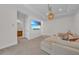 Cozy living room with a large television, comfy seating, and access to a nearby bathroom and hallway at 8847 Colonels Ct, Sarasota, FL 34240