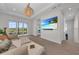 Open living room featuring a large television, comfortable seating, and scenic views from the sliding glass doors at 8847 Colonels Ct, Sarasota, FL 34240