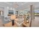 Stunning living room with fireplace, and an expansive view of the pool and golf course at 8847 Colonels Ct, Sarasota, FL 34240
