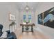 Bright office with a rustic desk, statement lighting, and large artwork creates an inspiring work environment at 8847 Colonels Ct, Sarasota, FL 34240