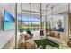 Inviting outdoor space with hanging daybeds overlooking a pool and golf course at 8847 Colonels Ct, Sarasota, FL 34240