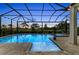Sparkling pool and spa with screened lanai and lovely twilight sky views at 8847 Colonels Ct, Sarasota, FL 34240