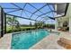 Inviting pool with spa and screened enclosure with lovely landscaping views at 8847 Colonels Ct, Sarasota, FL 34240
