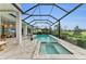 This screened pool features a connected spa with beautiful pavers and screened enclosure at 8847 Colonels Ct, Sarasota, FL 34240