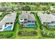 An aerial view of the home and back yard featuring a pool, spa and meticulously landscaped backyard at 8847 Colonels Ct, Sarasota, FL 34240