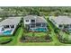 An aerial view of the home's screened lanai, pool, and lush landscaping and backyard at 8847 Colonels Ct, Sarasota, FL 34240