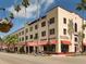 Charming view of the Historic KMI Building, part of the Venice Shopping Mall, with palm trees and sunny skies at 926 Capri Isles Blvd # 228, Venice, FL 34292