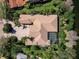 Aerial view of a large house with a tile roof, pool, manicured landscaping, and circular driveway at 7921 Waterton Ln, Lakewood Ranch, FL 34202