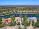An aerial view of a beautiful home by the lake surrounded by lush landscaping at 7921 Waterton Ln, Lakewood Ranch, FL 34202
