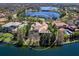Aerial view of the waterfront home with a pool and lush landscaping near a lake in a residential area at 7921 Waterton Ln, Lakewood Ranch, FL 34202