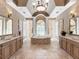 An elegant bathroom boasts a soaking tub, double vanity, large mirrors, and decorative lighting at 7921 Waterton Ln, Lakewood Ranch, FL 34202