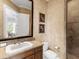 Charming bathroom featuring a classic vanity, neutral tones, and a glass-enclosed shower at 7921 Waterton Ln, Lakewood Ranch, FL 34202