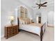 This beautiful bedroom features crown molding, a ceiling fan, and neutral-colored carpet throughout at 7921 Waterton Ln, Lakewood Ranch, FL 34202