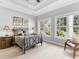Comfortable bedroom with large windows providing scenic views of the outside landscape at 7921 Waterton Ln, Lakewood Ranch, FL 34202
