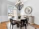 Bright dining room with a chandelier, a round table, and a sideboard at 7921 Waterton Ln, Lakewood Ranch, FL 34202