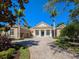 Beautiful property with circular brick driveway and lush landscaping at 7921 Waterton Ln, Lakewood Ranch, FL 34202