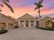 Expansive home with circular brick driveway and well-manicured landscaping at 7921 Waterton Ln, Lakewood Ranch, FL 34202