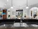 Gourmet kitchen featuring a double sink, black countertops, and views to the pool area at 7921 Waterton Ln, Lakewood Ranch, FL 34202