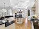 Open-concept kitchen featuring granite countertops, stainless steel appliances, and custom cabinetry at 7921 Waterton Ln, Lakewood Ranch, FL 34202